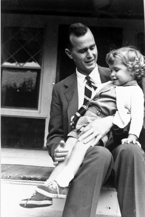 George Bush holding his daughter