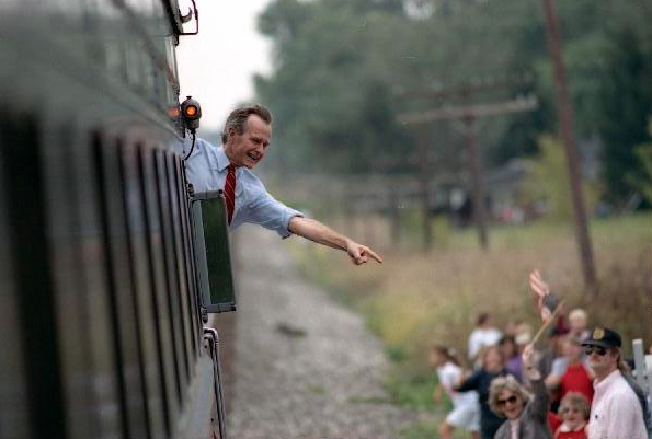 President Bush waves from the back of a train car