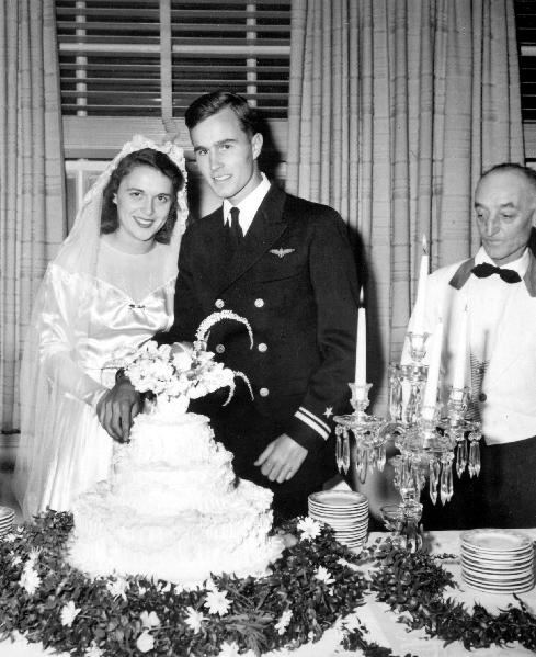 George and Barbara Bush cutting their wedding cake